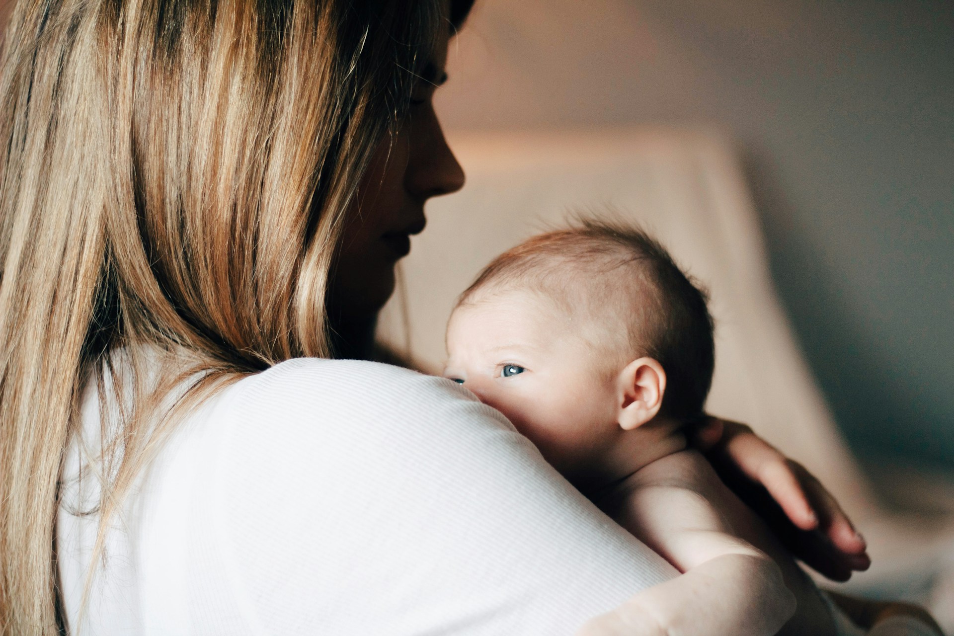 Mother embracing her children while receiving sleep consultation services from a trusted sleep consultant, focusing on gentle sleep training and holistic support for families.